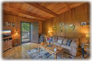 Living Room With Comfy Swivel Chair & Queen-Size Sleeper Sofa